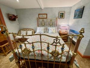 a bedroom with a metal bed in a room at Elsmere Heritage Gardens & Accom in Launceston