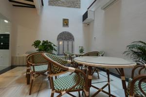 a dining room with a table and chairs at Casa Tomás Boutique Hotel in Seville