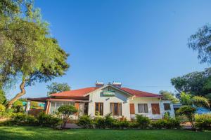 a house with a red roof at Crocodile Rock Lodge in Bulawayo