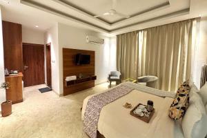a hotel room with a bed and a television at Vyom Boutique Hotel by Aramah in Rishīkesh