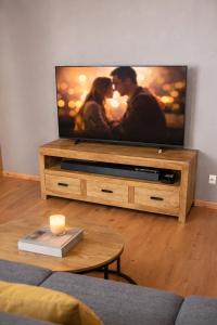 a living room with a flat screen tv at Le refuge de Séve - Loft de Yves in Momignies