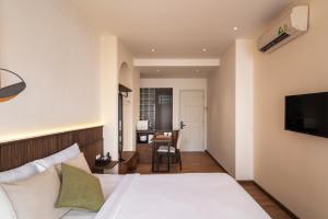 a hotel room with a bed and a desk at Saigon Maison 1988 BUI VIEN Centre in Ho Chi Minh City