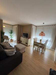 a living room with a couch and a table at Cardedeu City and Circuit apartment in Cardedeu