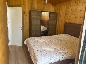 a small bedroom with a bed and a mirror at Šumska Duša in Banja Luka +33 photos