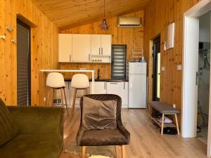 a living room with a couch and a kitchen at Šumska Duša in Banja Luka