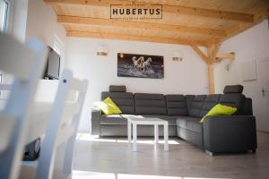 a living room with a couch and a table at Hubertus in Polanica-Zdrój