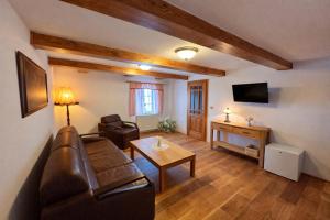 a living room with a couch and a table at U Bílého koníka in Kostelní Bříza