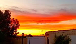 a sunset over a city with a building at La Villa Blanca in Pedralba