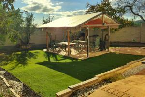 a gazebo with a table and chairs in a yard at La Villa Blanca in Pedralba +41 photos
