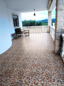 a room with a tiled floor with a table and chairs at La Villa Blanca in Pedralba