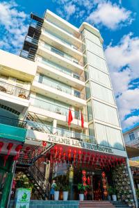 a building with chinese flags in front of it at Thanh Lich Hue Hotel in Hue
