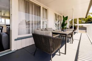 a patio with chairs and a table on a house at Belle Bonne Motel in Christchurch
