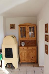 a room with a stove and a wooden cabinet at Ferienhaus Alpkönig in Missen-Wilhams