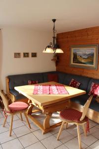 a dining room with a wooden table and chairs at Ferienhaus Alpkönig in Missen-Wilhams +10 photos