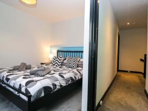 a bedroom with a bed and a mirror at Havelock Hideaway in Windermere