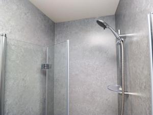 a shower with a glass door in a bathroom at Havelock Hideaway in Windermere +26 photos