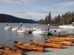 a group of boats docked at a dock on a lake at Havelock Hideaway in Windermere