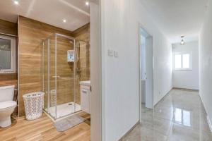 a bathroom with a glass shower and a toilet at Spacious 3BR Apartment close to Marsascala promenade in Marsaskala +22 photos