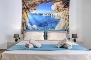 a bed with a mural on the wall at Spacious 3BR Apartment close to Marsascala promenade in Marsaskala