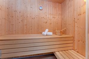 a wooden sauna with two towels on a wooden shelf at Nordstern in Schönberger Strand