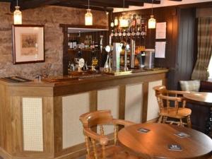 a bar with a table and chairs in a restaurant at The Stapylton Arms in Wass