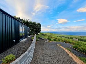 a train is parked next to a wall at Lothmore Lookout - Sunset in Kilmote