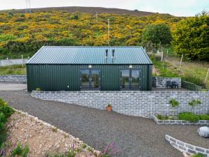 a green house with a brick retaining wall at Lothmore Lookout - Sunset in Kilmote