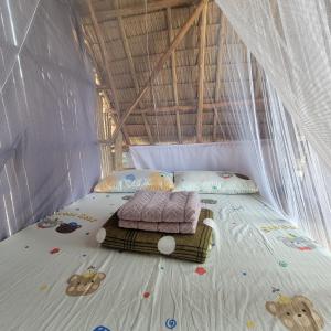 a bedroom with a bed in a tent at Island Crib in El Nido
