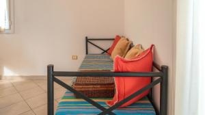 a bunk bed with red and blue pillows on it at Holiday Park Spiaggia e Mare in Porto Garibaldi +11 photos
