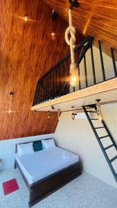a bed in a room with a wooden ceiling at Dedunu Guest in Badulla