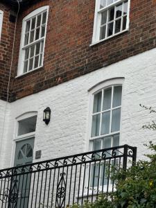 a brick building with windows and a black fence at Rooftops in Louth +5 photos