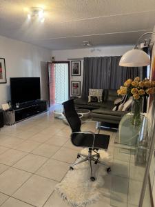 a living room with a glass table and a couch at House by balinty in Johannesburg