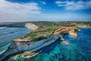 an aerial view of a cliff with the ocean at Spacious 3BR Apartment close to Marsascala promenade in Marsaskala