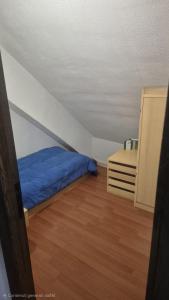 a bedroom with a blue bed and a cabinet at ACAMPORA CIRO Appartamento Privato Club Primula in Pescasseroli +10 photos