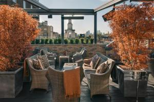 a row of chairs and tables on a rooftop patio at The Chesterfield Mayfair in London