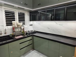 a kitchen with white marble counters and a sink at Tranquil service apartment in Chikmagalūr +5 photos