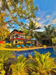 a resort with a swimming pool in front of a house at Stone Manor Inn in Concepcion