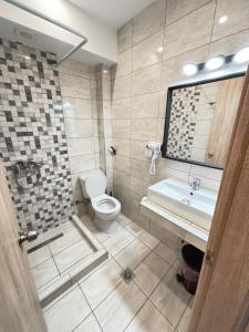 a bathroom with a tub and a toilet and a sink at Minas Luxury Studios in Stavros +39 photos