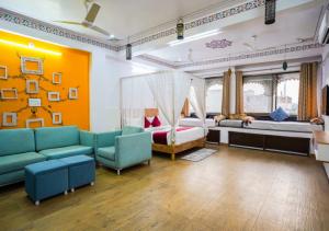 a living room with a couch and a bed at Saga by Lake in Udaipur