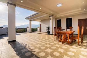 a patio with a wooden table and chairs at Boeung Prolet Guest House in Kampot