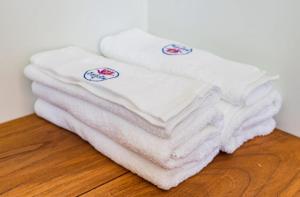 a stack of white towels sitting on a wooden floor at Boeung Prolet Guest House in Kampot +19 photos