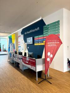 a waiting area in a hospital with a sign in the middle at HausPension in Vienna