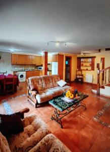 a living room with a couch and a table at Alojamiento La Plaza in La Franca