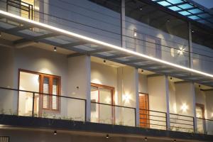 an external view of a building with lights at Gentur Enclave in Mananthavady