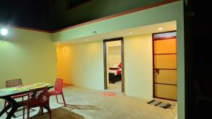 a room with a table and chairs and a dining room at Mercury JKR Residency in Yelagiri