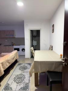 a living room with a table and a kitchen at Melvina in Pančevo