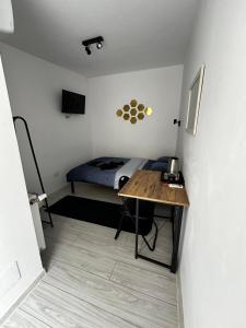 a small bedroom with a bed and a desk at ANA City Rooms in Cluj-Napoca