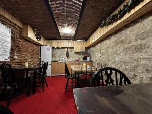 a dining room with tables and chairs and a kitchen at ANA City Rooms in Cluj-Napoca +35 photos
