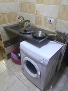 a washing machine with a sink on top of it at Egypt Pyramids Hotel in Cairo
