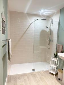 a shower with a glass door in a bathroom at Seaview Cottage in Llanddulas +6 photos